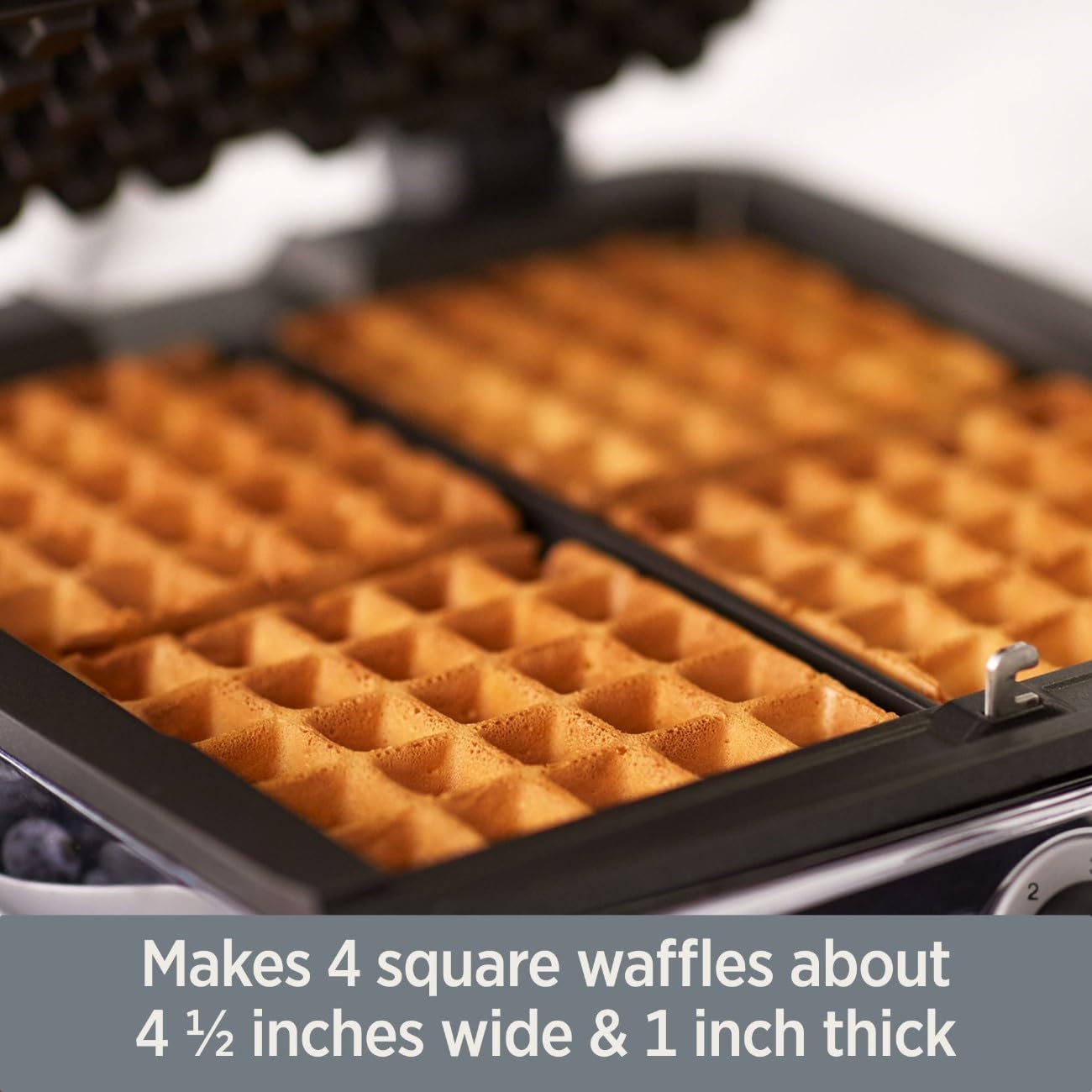 All-Clad Belgian Waffle Maker making 4 square waffles about 4 ½ inches wide and 1 inch thick.
